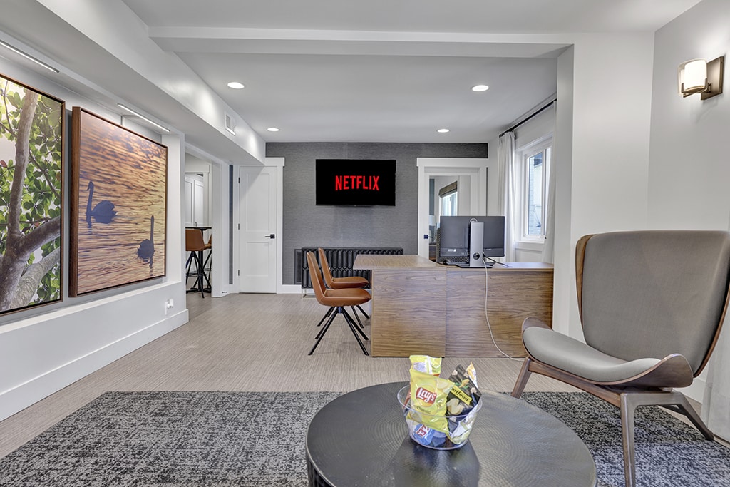 A living room with a Netflix sign on the wall.